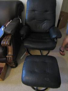 lot 186 image: Black leather reclining chair with matching footstool