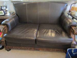 lot 185 image: Love seat brown leather couch mint condition solid wood base and trim  that matches 184