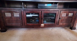 lot 23 image: CHERRYWOOD TELEVISION TABLE  W DOORS - 75 L X 28 H  X 20D 9 STILL HAS TAGS ATTACHED)