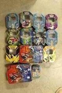 lot 54 image: Lot of 13 Pokemon Trading Card Game Tin Boxes, Various Styles and Conditions, for Pokemon Card and Toy Storage