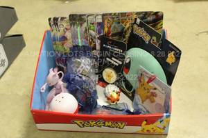 lot 55 image: Box of Various Pokemon Trading Card Game Toys and 20 Items Including Oversize Card, Sunglasses, Pop Socket, Mewtwo Pikachu and More