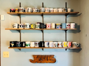 lot 20 image: Lot of 3 Shelves wApproximately 70 Coffee Cups From Various States &amp Tourist Locations and Jesus Wall Hanging&nbsp