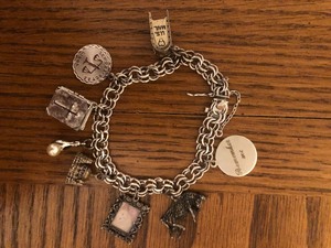 lot 121 image: American Sterling Charm Bracelet wSeveral Sterling Silver Charms (some not sure)