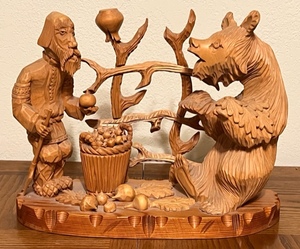 lot 245 image: 14.5x 12 x 6.5 Russian Made Hand-Carved Wooden Man Offering Bear An Onion