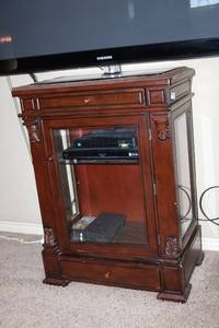 lot 42 image: TV Stand with Glass Door Front and glass sides, contents not included, 31W x 19D x 41 Tall