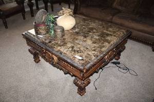 lot 48 image: Casa Mollina 42 Square Marbled top Coffee Table, dark brown finish, has Ashley Furniture tag, contents not included