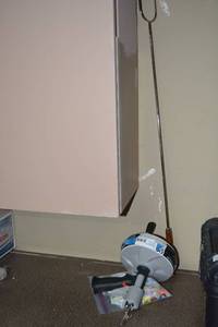 lot 83 image: 25Ft. Kink Resistant Cable Pipe Snake, bag of Earplugs, and campfire cooking rod
