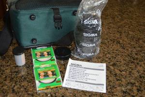 lot 131 image: Camera Bag, Sigma Camera Lens, Hoya Filter and Film Roll