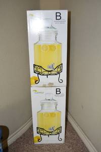 lot 139 image: Two Glass Beverage Dispensers with Wire Racks
