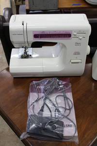 lot 16 image: Janome New Home Sewing Machine with Foot Pedal and manual, Model HF5024