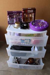 lot 100 image: Bathroom Lot Unopened Perfume and Cologne Sets, Wall Clock, Candle, Sponges and More