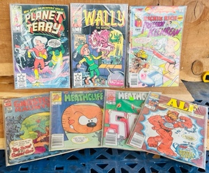 lot 297 image: 7 ASSORTED COMIC BOOKS - GHOSTLY HAUNTS  ALF  HEATHCLIFF  PLANET TERRY #1  &nbspWALLY THE WIZARD #1  RICHIE RICH &amp PROFESSOR KEENBEAN #1