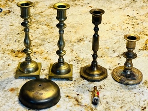 lot 54 image: FOUR 8.5 - 5 BRASS CANDLE HOLDERS w4 BRASS BELL &amp 2.5 SUNFLOWER BRASS BOTTLE CIGARETTE LIGHTER