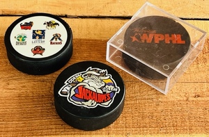 lot 87 image: Three Western Professional Hockey League Hockey Pucs - One Includes the Now Defunct Waco Wizards