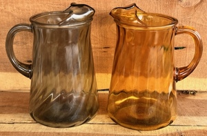 lot 264 image: Two Vintage Indiana Glass Smokey Gray and Amber Spiral Glass Pitchers