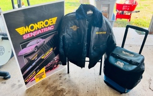lot 272 image: Vintage 24x36 Monroe Advertising Sign, MonroeFox Sports Radio Rolling Travel Bag wHandle, &amp Monroe Kodiak Island Alaska 1989 Jacket