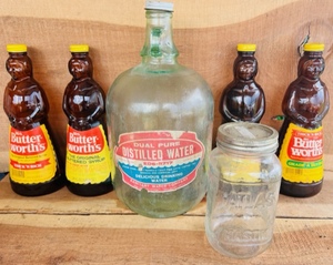 lot 276 image: Vintage Glass Distilled Water Jug, Atlas Mason Jar, and Four Mrs. Butter-Worths Bottles from the 70s With Metal Caps