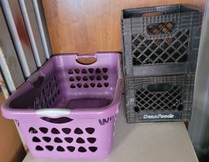 lot 25 image: CLOTHES BASKET AND MILK CRATES AS SHOWN.
