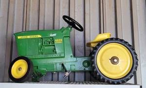 lot 4 image: ERTL JOHN DEERE 4020 DIESEL PEDAL TRACTOR AS SHOWN. ONE WHEEL NEEDS ATTENTION. SEARCH IT UP