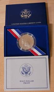 lot 80 image: 1986 U.S. LIBERTY HALF DOLLAR COIN IN CASE AS SHOWN.