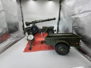 lot 22 image: Vintage 1960s GI Joe jeep, with missile launcher and trailer, spotlight. the different color green piece had been repaired