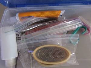 lot 106 image: small tub of nail files, clippers etc.