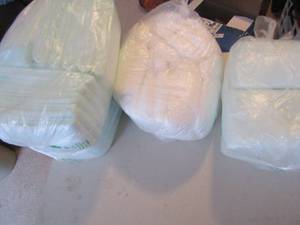 lot 130 image: 3 bags of bed pads and a bag of incontinence underwear