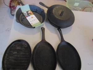 lot 168 image: 2 cast iron skillet plates, and 2 cast iron skillets one with lid