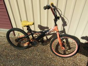 lot 243 image: Double take black and orange boys bike. Needs seat repaired