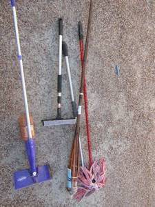 lot 245 image: Opened cleaning supplies- mop, Swiffer, window wiper fluid and tiki torch