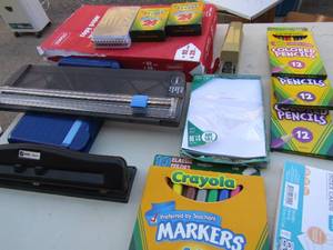 lot 48 image: Tub of school supplies- markers, crayons, paper cutter, printer paper and more