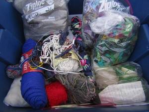 lot 51 image: Tub of fabric pieces, yarn wool, knitting needles