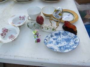 lot 54 image: 2 trinket eggs, 2 altrohia Austria mini bowls, small glass lion, handmade Ngwenya lion, Chastagner tea cup and plate