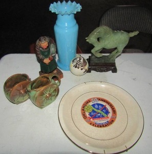 lot 63 image: Tall pale blue glass vase , green horse on stand, hand carved kitchen man,2 wagon wheel coffee cups