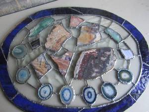lot 5 image: Oval hanging stained glass with assorted stones  incl. geode slices  25 X 19