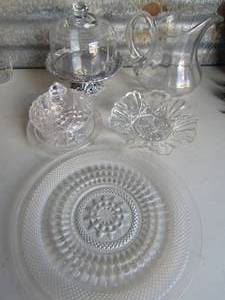 lot 121 image: PRESSED GLASS ROUND , COVERED CHEESE DISH, Glass pitcher , COVERED CAKE STAND W SILVER BASE, FLUTED BOWL