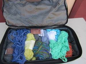 lot 143 image: SEVERAL SKEINS OF YARN IN  A Backpack