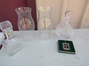 lot 21 image: Two 12 oil lamp covers , 10x5 glass decanter, Liquor bottle with cork, 11 shell shape decanter with cork