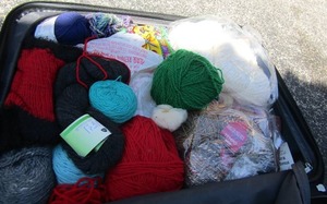 lot 144 image: Maroon Jeep suitcase with Several  assorted yard skeins