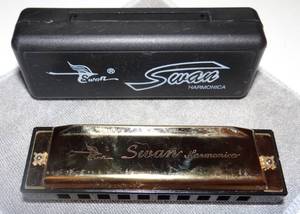 lot 54 image: SWANN GOLD TONE KEY OF C HARMONICA IN HARD CASE