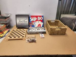lot 135 image: Selection of games in a basket- also has Pictionary which is not in photos