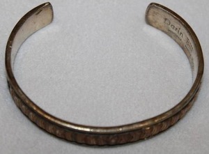 lot 125 image: Navajo artisan Darin Bill (Sacaton, AZ, b.1965-d. 2003, of Towering House People Clan) signed Sterling silver and 120 12K gold filled cuff bracelet. Marked Darin Bill Sterling 120 12K GF (with spider hallmark)