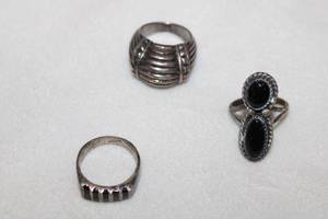 lot 126 image: (3) Sterling silver rings. Includes dome ring (size 7.5, marked 925), Taxco Black Onyx inset ring (size 8, marked Mexico, 925 and artisan initials) and Black Onyx 2 stone ring (Size 7.5, Marked 925)