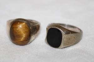 lot 128 image: (2) Taxco Sterling silver gemstone rings. Both size 13. Tigers Eye (Marked Mexico 925 TC-515 and inset Black Onyx (has chip, Marked Mex 925 TH-105