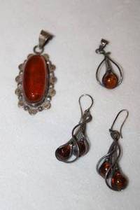 lot 131 image: (4) Sterling silver Amber pieces. Includes 2 pendants (1 marked 925 Mexico and a pair of art nouveau earrings. Marked 925. Large pendant about 2.5L