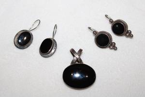 lot 134 image: Sterling silver Black Onyx jewelry. Includes (2) pairs of earrings (both marked925) and a East-West bezel set cabochon pendant with criss cross bale (unmarked)