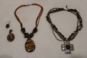 lot 175 image: Tiger Eye and faux Tiger Eye jewelry. Includes 2 necklaces, a pendant and solitaire earring.