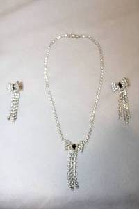 lot 178 image: Midnight blue and white crystal 16 necklace and matching earrings in bowtie form.