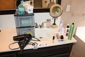 lot 97 image: Bathroom Lot Hair Dryer, Medicated Knee Sleeves, Sports Tape, Small Decorative Mirror Stand, and More
