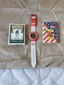lot 27 image: Selection of Olympic playing cards and a Coca Cola World Cup watch